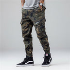 Front view of men’s camo harem jogger pants featuring slim tapered ankle streetwear design