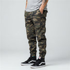 Front view of men’s camo harem jogger pants featuring slim tapered ankle streetwear design
