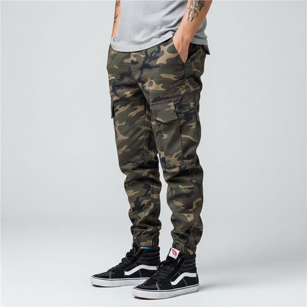 Front view of men’s camo harem jogger pants featuring slim tapered ankle streetwear design