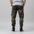 Front view of men’s camo harem jogger pants featuring slim tapered ankle streetwear design