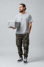 Front view of men’s camo harem jogger pants featuring slim tapered ankle streetwear design