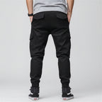 Front view of men’s camo harem jogger pants featuring slim tapered ankle streetwear design