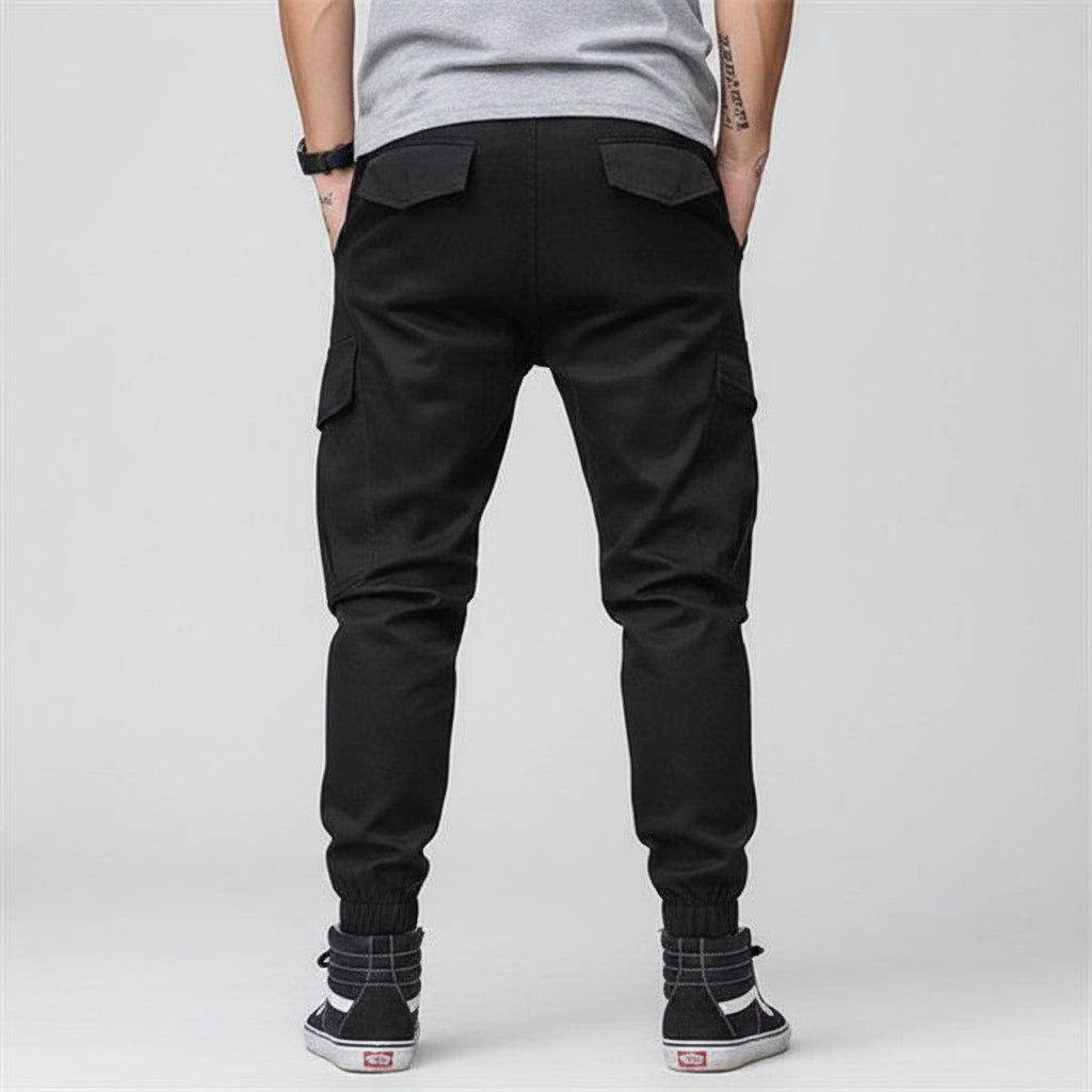Front view of men’s camo harem jogger pants featuring slim tapered ankle streetwear design