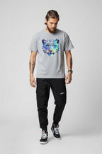 Front view of men’s camo harem jogger pants featuring slim tapered ankle streetwear design