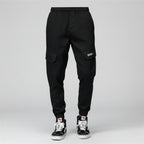 Front view of men’s camo harem jogger pants featuring slim tapered ankle streetwear design