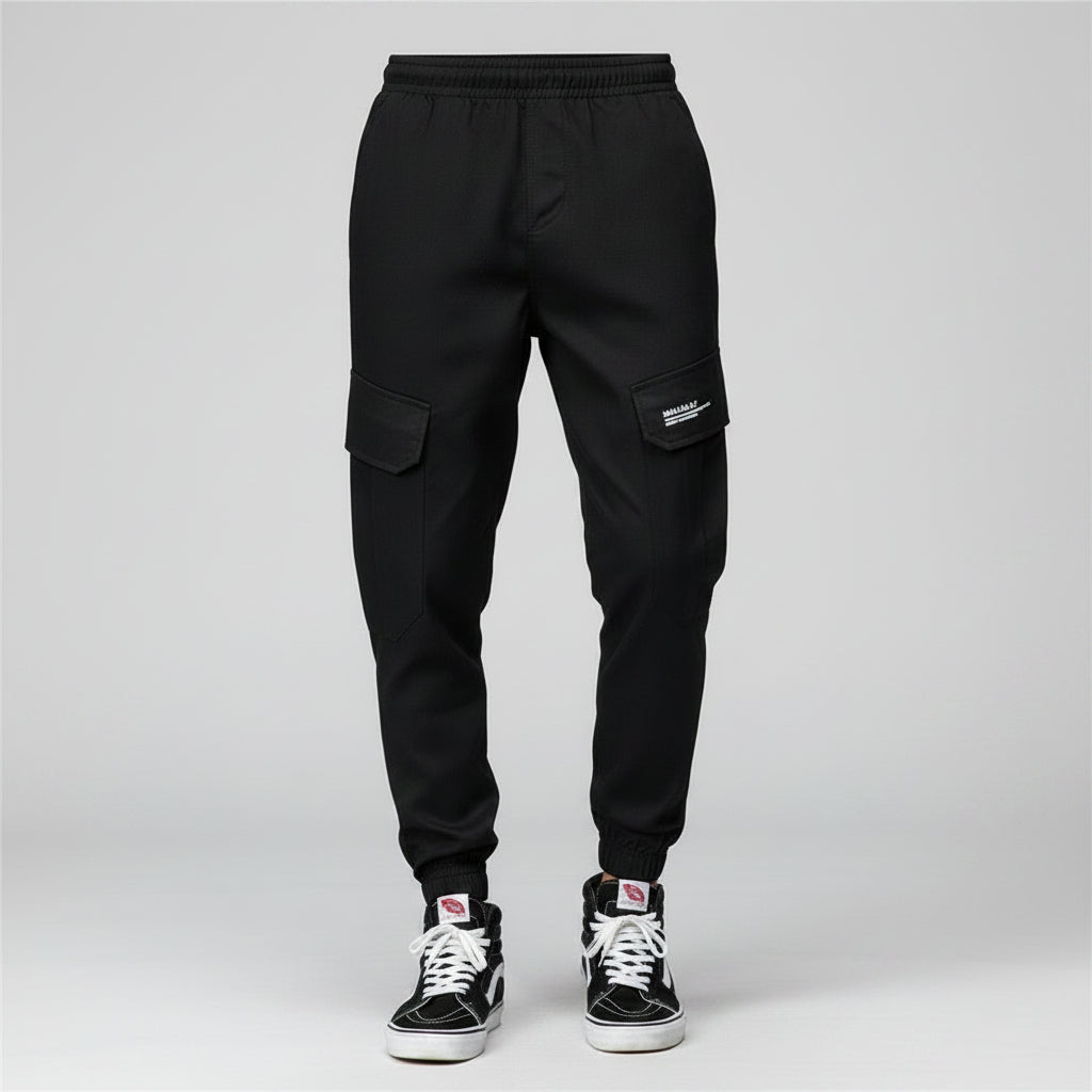 Front view of men’s camo harem jogger pants featuring slim tapered ankle streetwear design