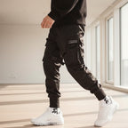 Front view of men’s ribbon harem cargo joggers with elastic waist and streetwear style
